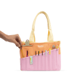 Load image into Gallery viewer, A hand holding a yellow pencil case with various writing utensils and a clip inside, against a black background.
